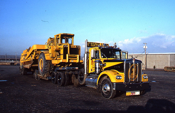 IHH hauling a Scraper on a Jump Trailer
